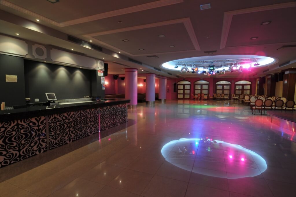 Dance floor and bar under coloured lighting
