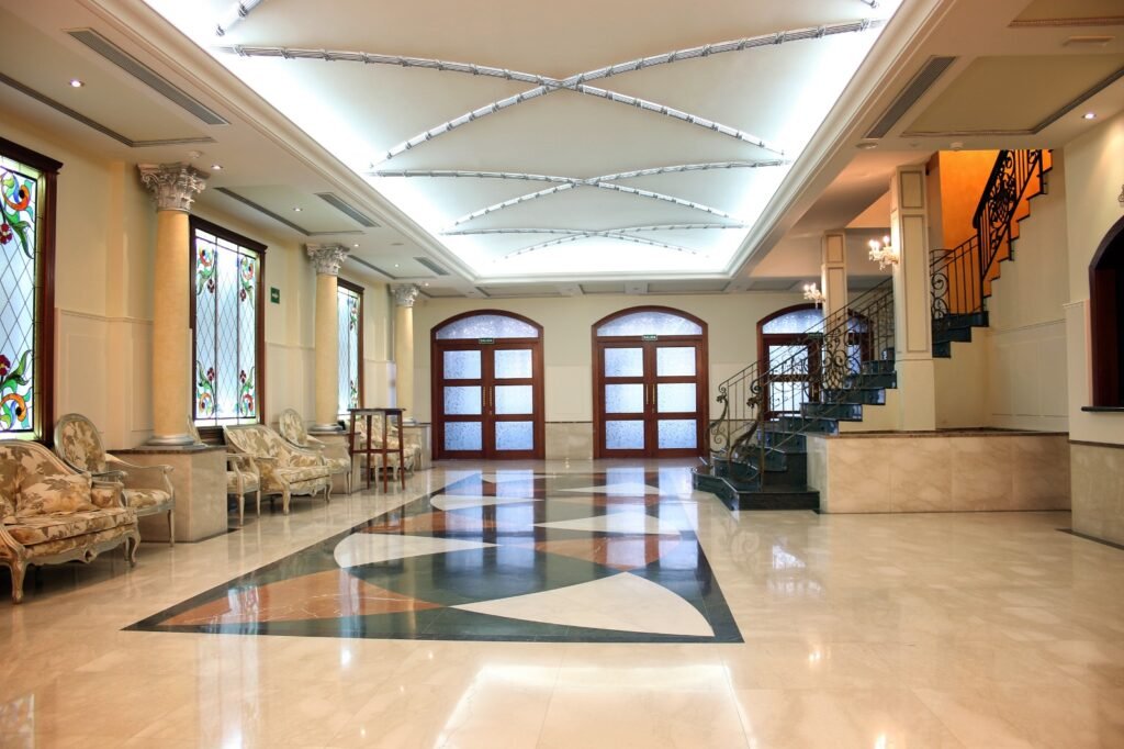 Foyer with stained-glass windows, columns and inlaid marble floor