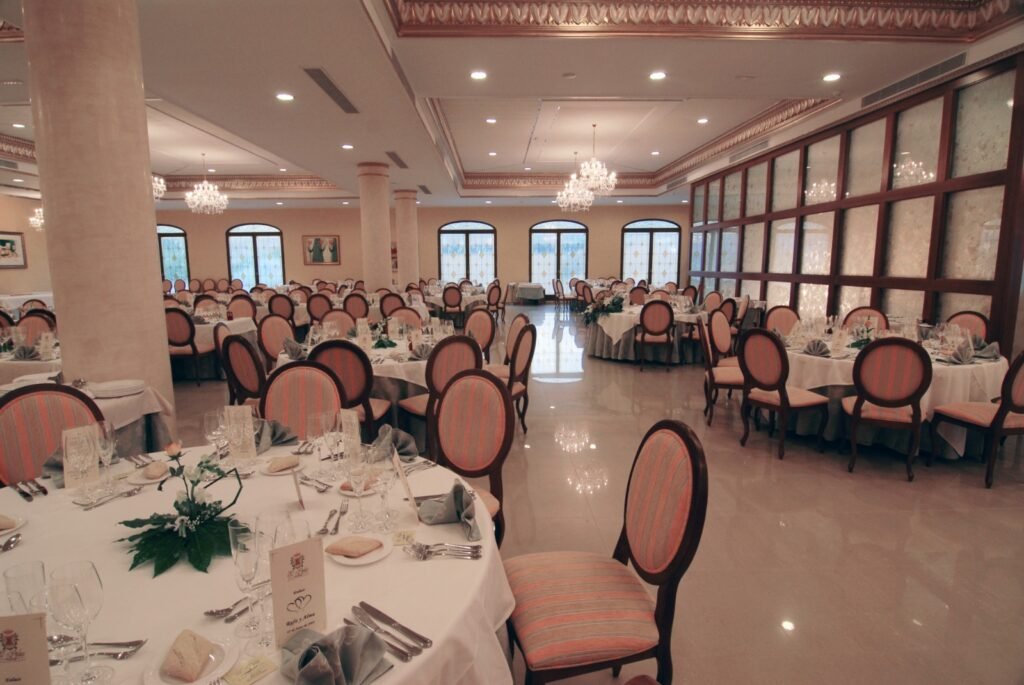 Banquet hall laid for a wedding, with chandeliers