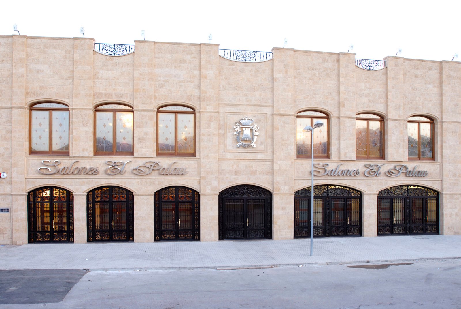 The El Palau facade in La Vall d’Uixó — stone frontage with arched stained-glass windows